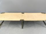 an old wooden table with metal legs and a wooden top