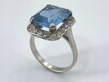a close up of a ring with a blue stone in it