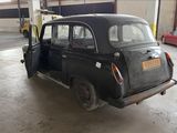 a small black car parked inside of a garage