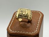 an image of a gold ring on a brown leather box