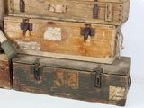 three trunks stacked on top of each other on a table