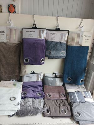 a lot of towels on a shelf in a store