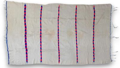 a white rug with red and blue stripes on it