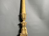 an antique wooden candle holder on a gray background
