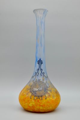 a glass vase with a yellow and blue design on it