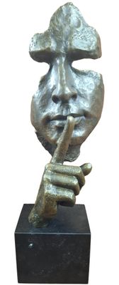 statue of a man with a finger on his lips