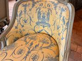 a yellow chair with blue and white designs on it