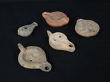 several different types of pottery items are displayed on a black surface