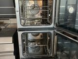 three ovens stacked on top of each other in a kitchen