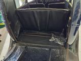 a car that is sitting in the garage with the door open