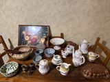 a wooden table with a bunch of dishes and bowls on it