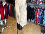 an image of a clothing store with a mannequin in front of it