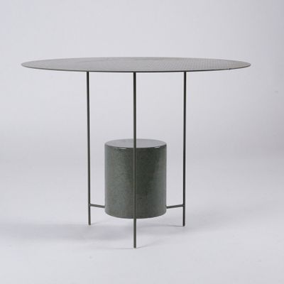 an image of a round table with a metal base and a glass top