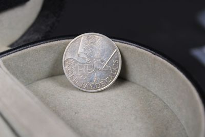 a silver coin sitting inside of a box on a table