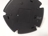 a black plastic object on a white surface