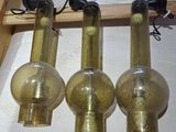 three glass lamps that are sitting on a table