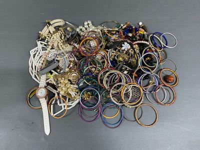 a pile of assorted bracelets and rings on a table