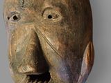 an image of a wooden mask with horns on it