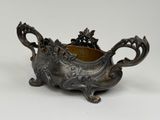 an antique silverplated bowl with a floral design on the bottom