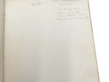 an open book with writing on it on a white surface