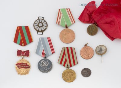 some medals and medals are laying out on a white surface