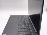a laptop computer sitting on a table with a keyboard