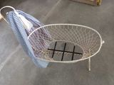a basket that has some clothes hanging out of it