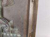 a picture of a metal plaque with a bird on it