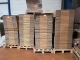 many stacks of cardboard on a pallet in a warehouse