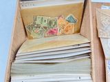 a wooden box filled with lots of stamps and envelopes
