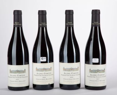 trois bouteilles de vin sont alignées sur une surface blanche
