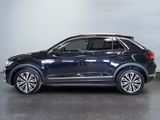 the volkswagen suv is parked in a garage with a white wall