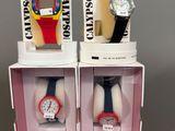 two watches are in a box on a gray surface