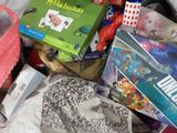 a bag full of toys and games sitting on the floor