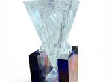 a glass vase with a diamond on top of it
