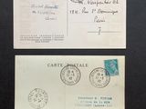 two envelopes with stamps on them sitting on a table