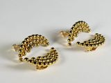 two pairs of gold earrings with beads on them on a white surface