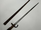 two old swords on a white surface with a black handle