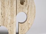 a white sculpture with a hole in the middle of it
