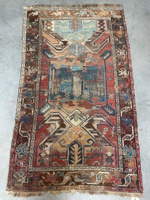 an old rug with a colorful design on it