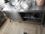 a stainless steel counter with pots and pans on top of it