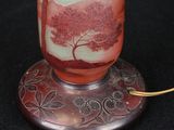 a glass vase with a tree on it on a stand