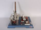 a small model of a steam engine on a blue platform