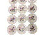 six white plates with floral designs on them on a white surface