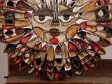 a sculpture of a face made out of spoons on a table