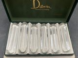 a box with six silver spoons inside of it