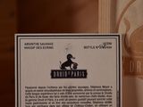 a label on a bottle of wine on a table
