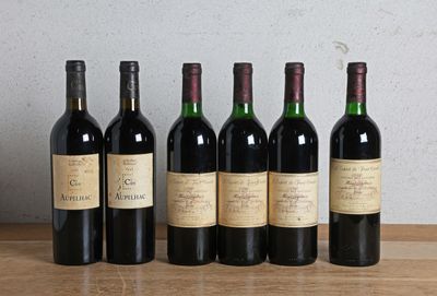 six bottles of wine are lined up on a wooden table