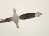 a close up of a sword with a metal handle