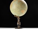 an old globe on a stand with a black background